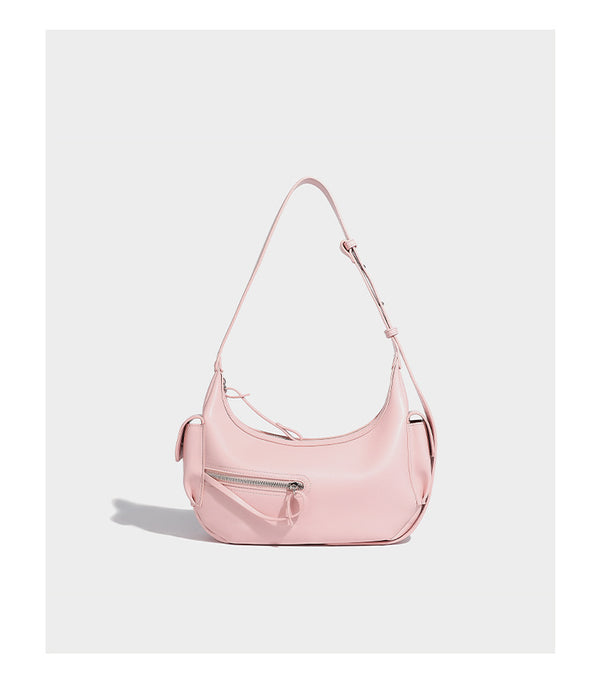 Smooth leather-look crescent shoulder bag with front zip pocket, side flap pockets, adjustable strap, and silver-tone, detail