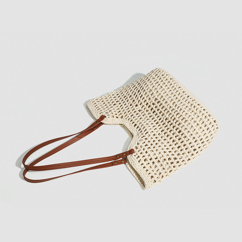 Open-knit woven tote bag with leather-look shoulder straps and brass-tone hardware in off-white, detail view 4