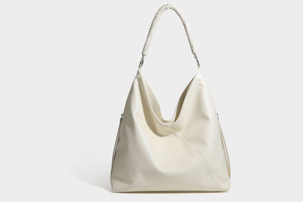 Large slouchy hobo shoulder bag with braided top handle, smooth glossy leather-look finish, and silver-tone ring hardware