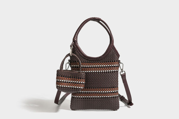 Color-block woven tote bag with rounded leather-look handles, detachable crossbody strap, and matching mini clip-on pouch in