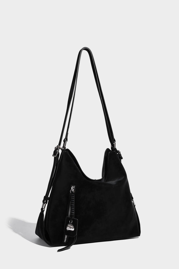 Slouchy hobo tote bag with matte leather-look finish, triangular silhouette, front zip pocket, and adjustable shoulder strap