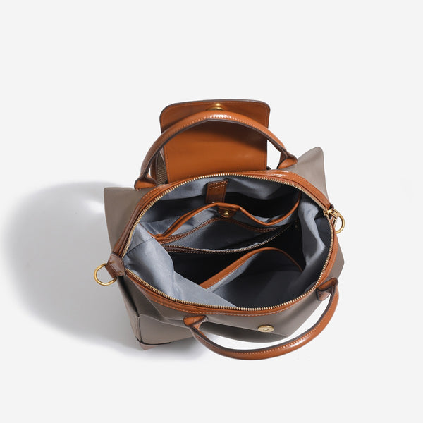 Large matte nylon backpack handbag with cognac leather-look trim, snap flap, and gold-tone hardware, detail view 4