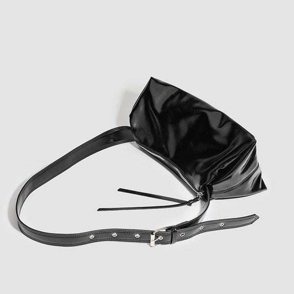 Black glossy leather-look slouchy shoulder bag with gathered top, zip tassel closure, and long adjustable silver-buckle