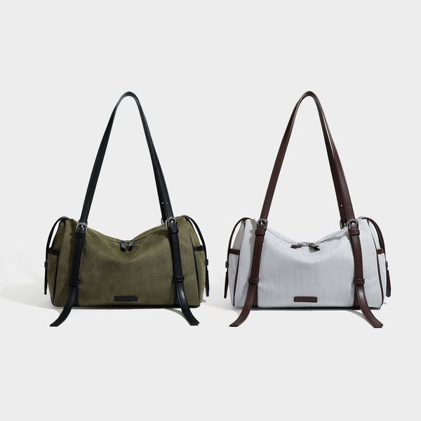 Schultertasche in Olivgrün aus Canvas im Zylinderstil mit Riemen in schwarzer Lederoptik, Reißverschluss oben und silberfarbenen Beschlägen, Detailansicht