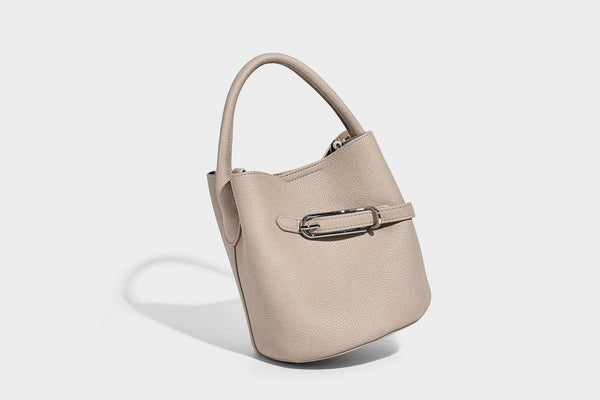 Mini pebbled leather-look bucket bag with front buckle strap, silver-tone hardware, top handle, and detachable shoulder