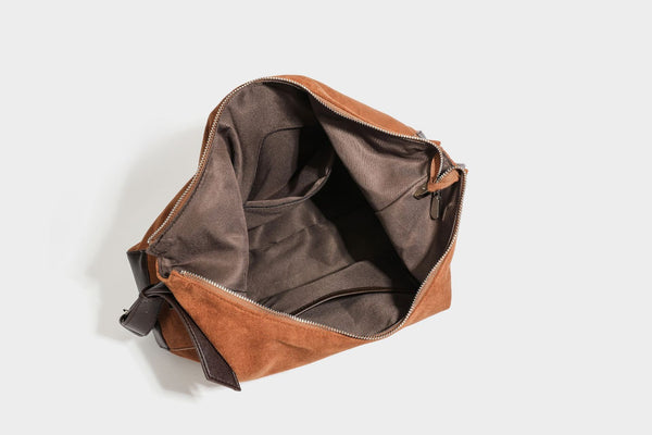 Slouchy cognac brown matte suede-look hobo shoulder bag with dark brown leather-look trim, top zip closure, front flap