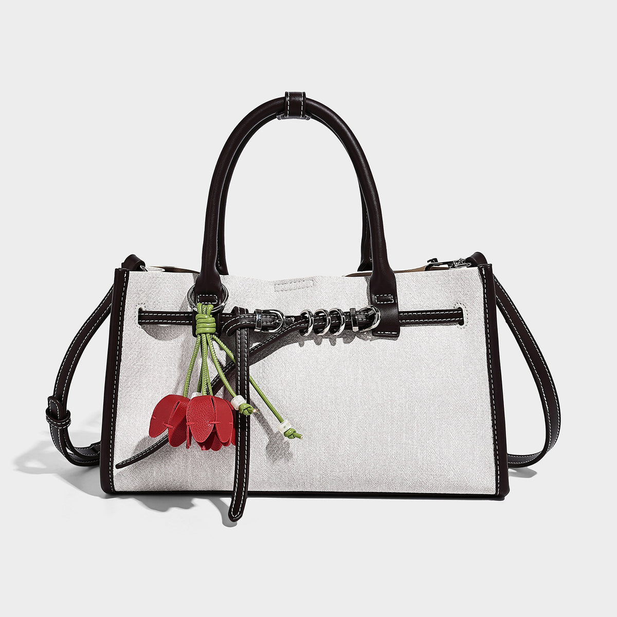 Structured rectangular tote satchel in denim-look fabric with dark trim, knotted front strap hardware, and detachable, detail