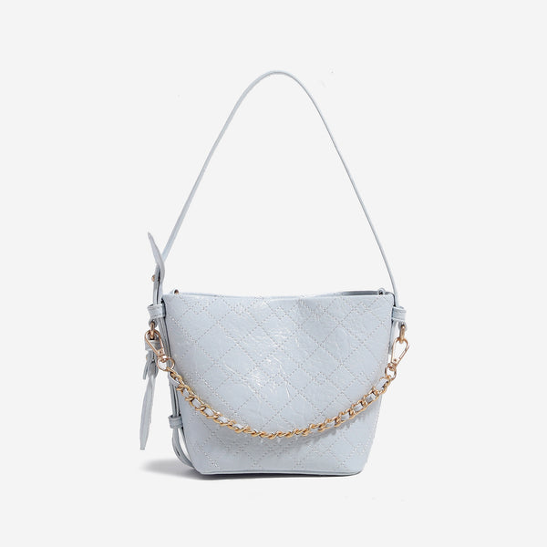Small diamond-quilted bucket bag with gold-tone chain accent, heart strap detail, hanging tag, and matching zip coin pouch