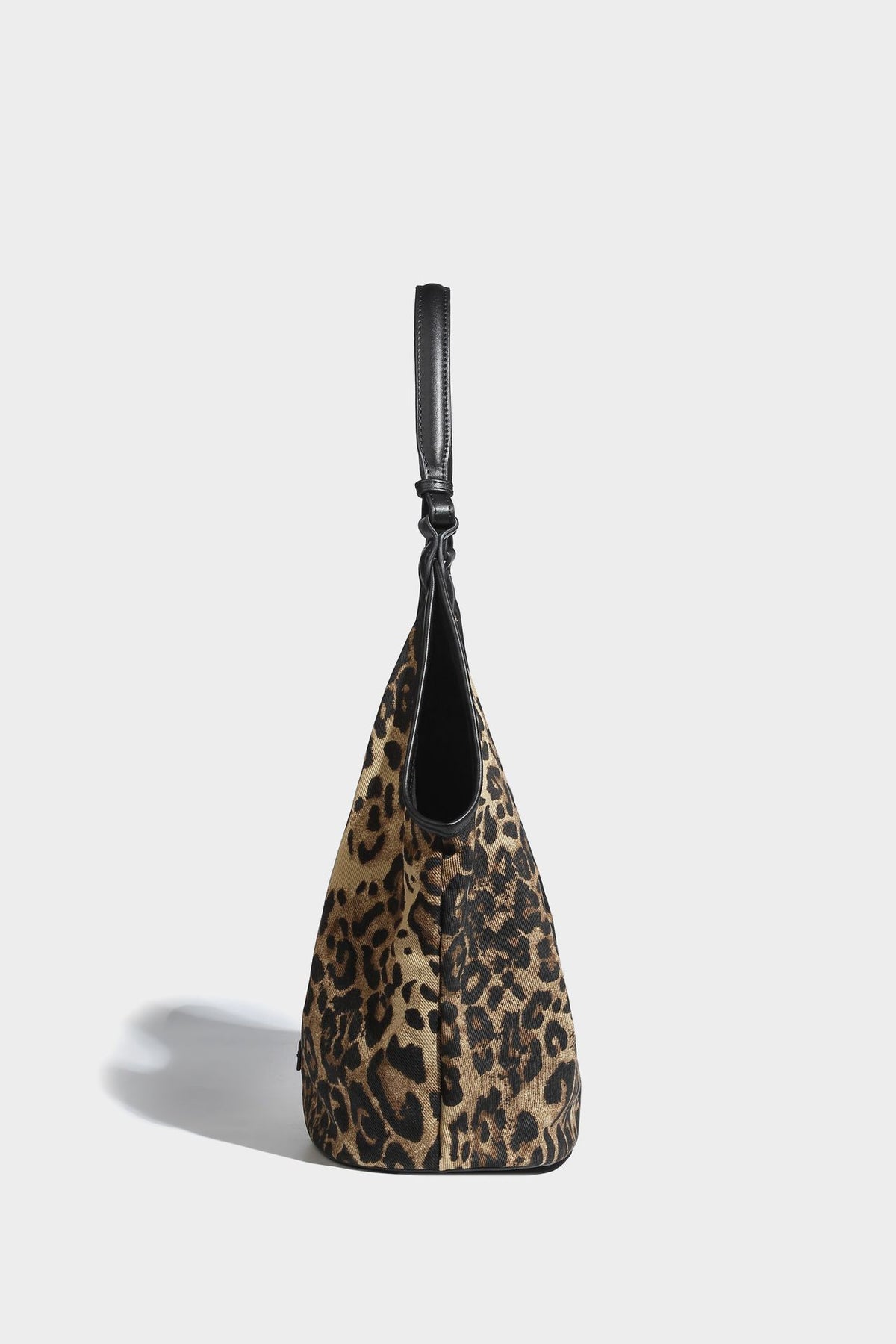 Slouchy brown leopard jacquard hobo tote bag with black leather-look trim and single shoulder strap, shown with black, detail