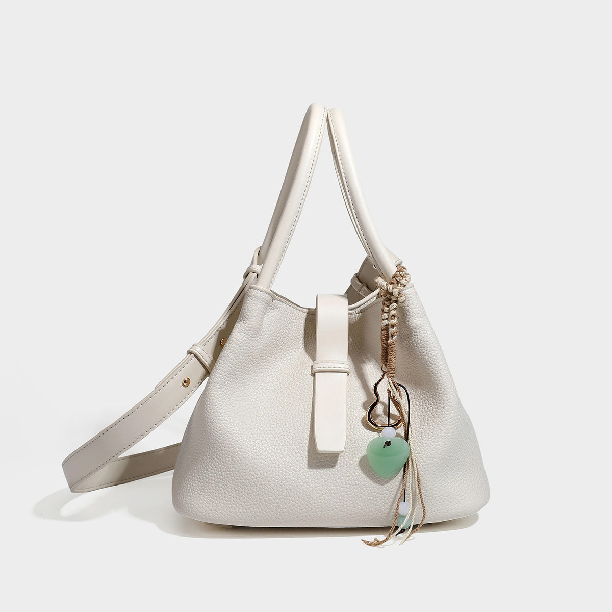 Pebbled leather-look bucket tote bag with rolled double handles, drawstring closure, braided cord charm, and detachable