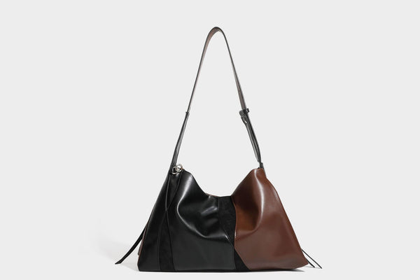 Two-tone black and brown leather-look slouchy shoulder bag with beaded tassel charm and silver-tone hardware, detail view 26