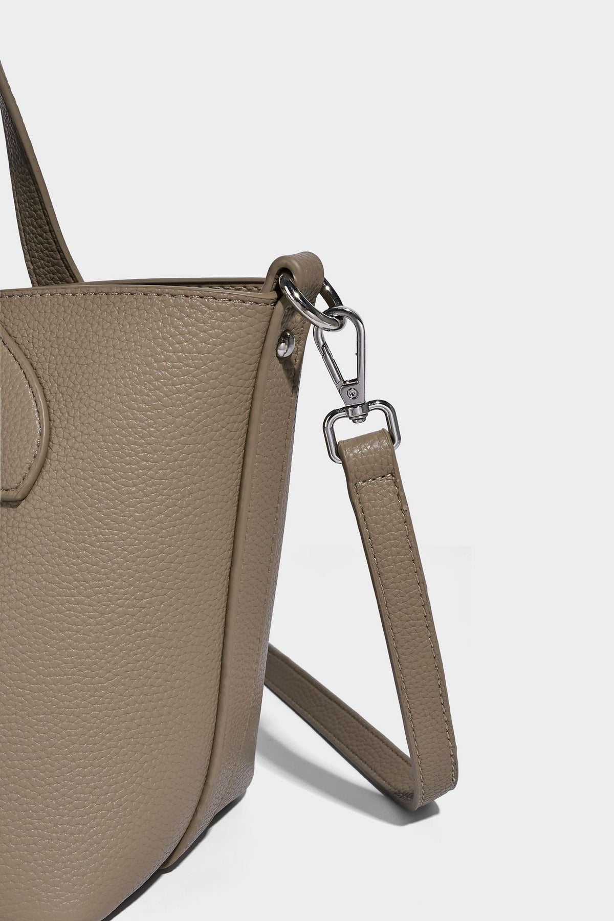 Compact pebbled bucket tote bag with elephant charm, twin top handles, and detachable crossbody strap, detail view 16