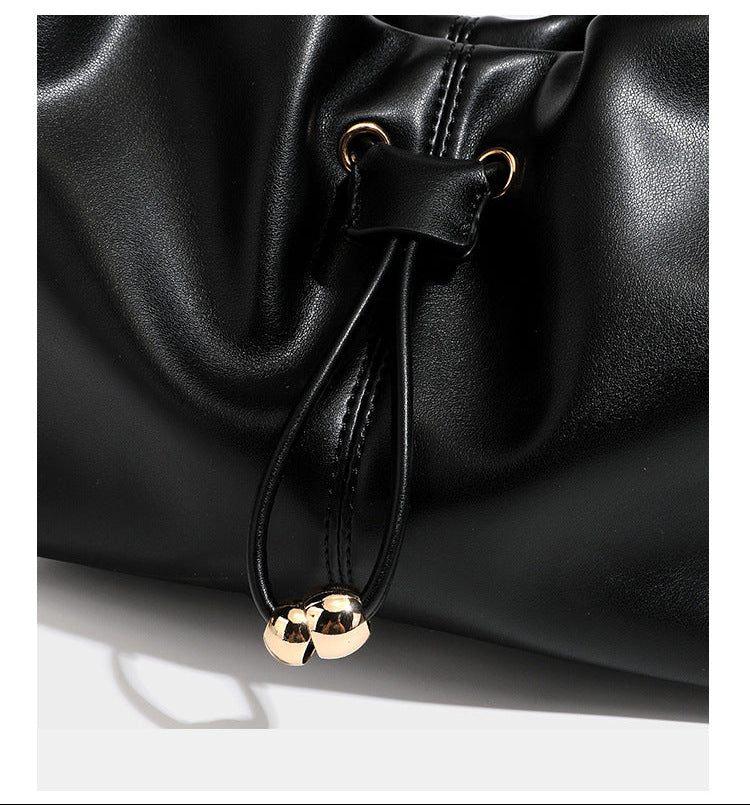 Slouchy hobo bag with smooth leather-look finish, drawstring cinch closure, and gold-tone bead hardware, detail view 19