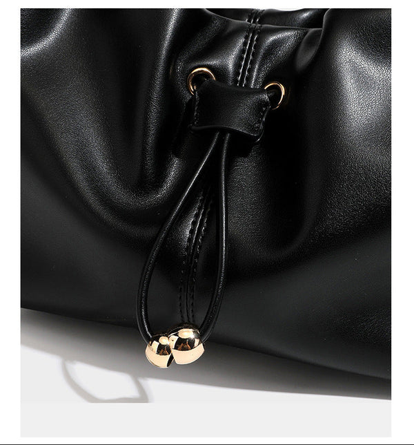 Slouchy hobo bag with smooth leather-look finish, drawstring cinch closure, and gold-tone bead hardware, detail view 19
