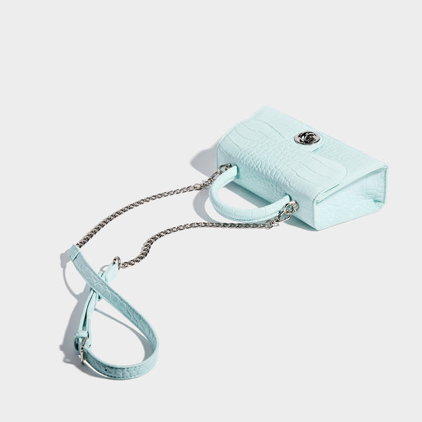 Mini croc-embossed glossy structured handbag with silver-tone turn-lock clasp and short top handle, detail view 4