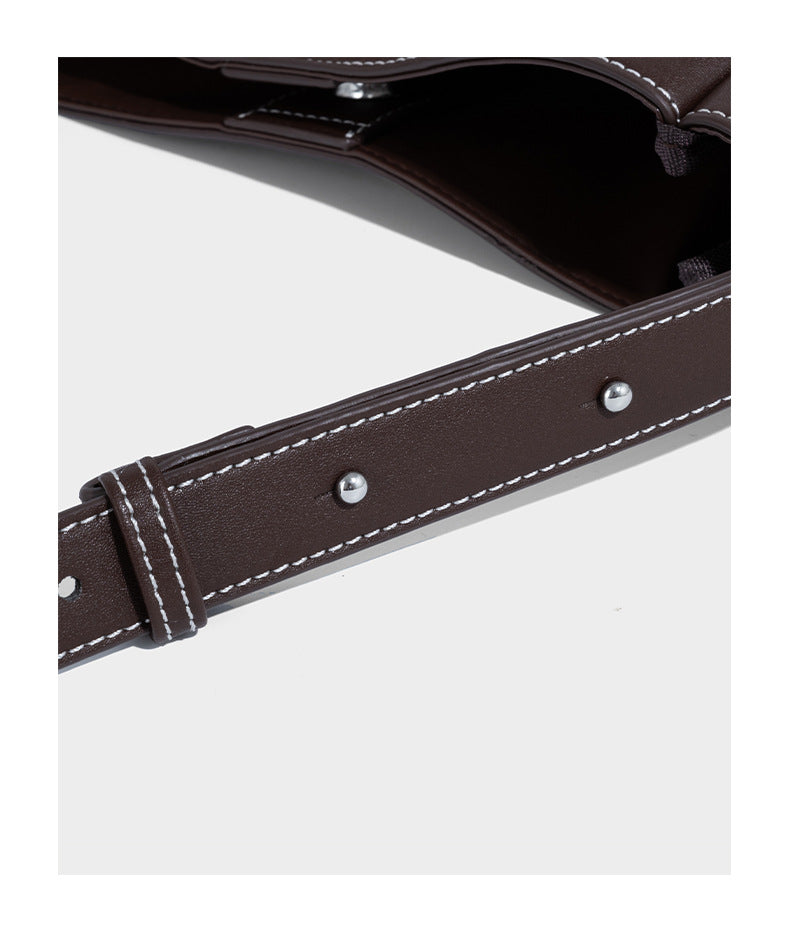Structured dark brown leather-look bucket bag with white contrast stitching, front wraparound belt buckle strap, and long