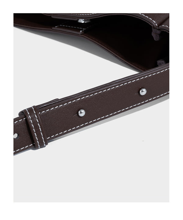 Structured dark brown leather-look bucket bag with white contrast stitching, front wraparound belt buckle strap, and long