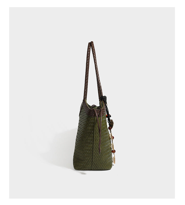 Woven tote bag with braided shoulder straps, drawstring closure, and dangling metal-and-bead charm, detail view 16