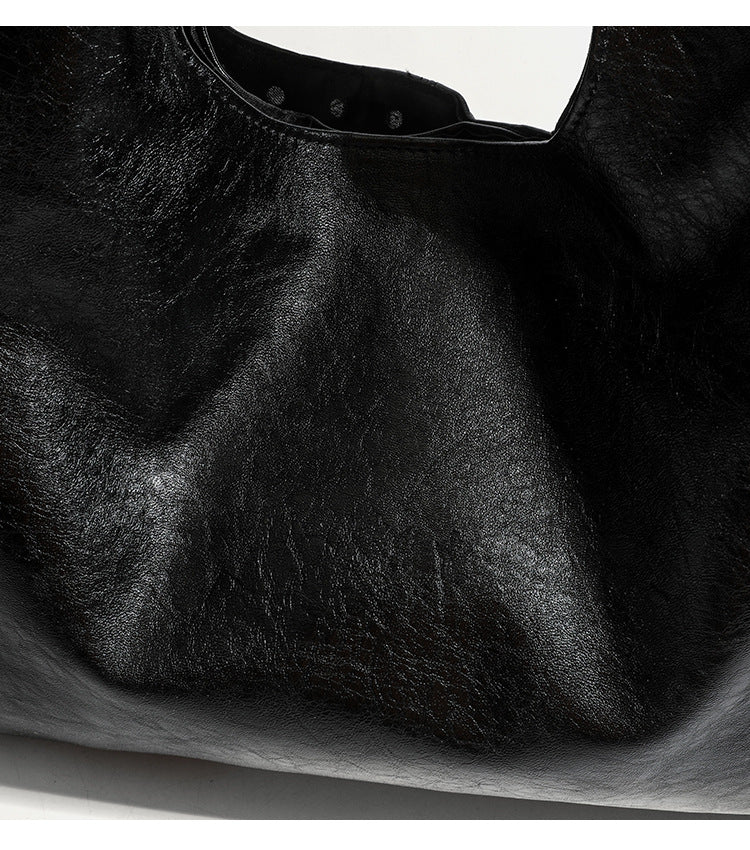 Large slouchy hobo shoulder bag with silver eyelet trim and glossy leather-look finish, detail view 13