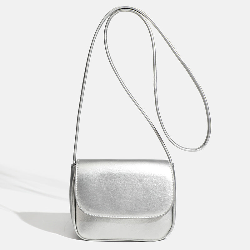 Compact rounded rectangular flap crossbody bag with glossy leather-look finish and long shoulder strap, detail view 8