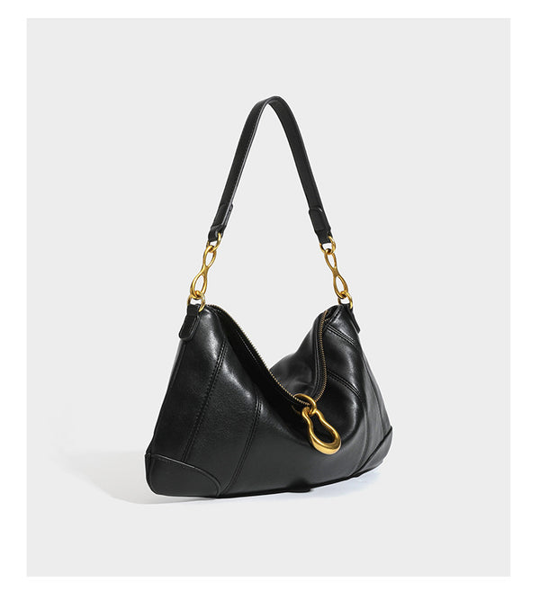 Slouchy denim shoulder bag with dark leather-look trim, gold-tone chain-link hardware, and top zipper closure, detail view 14