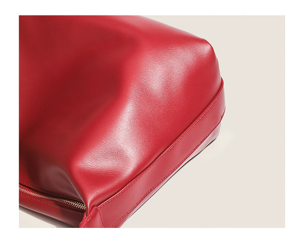 Large slouchy hobo shoulder bag in smooth leather-look finish with single long strap and gold-tone zip closure, detail view