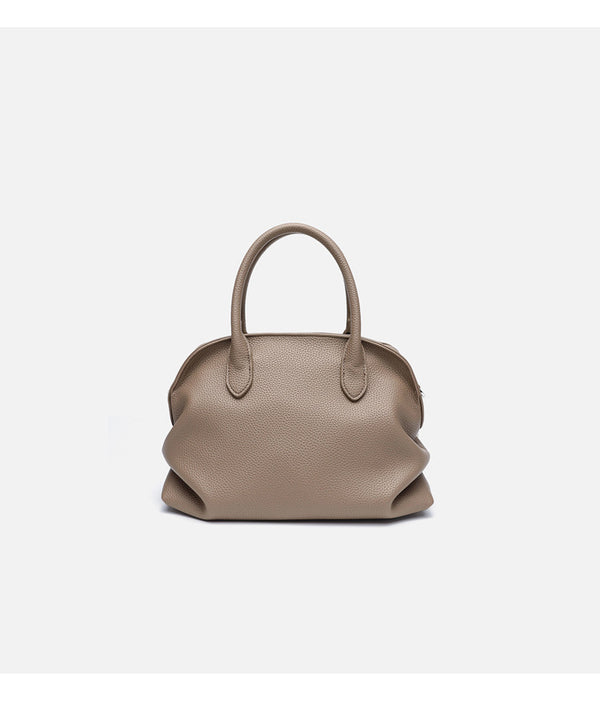Rounded dome shell handbag in pebbled leather-look finish with twin top handles, zip closure, decorative horse charm, and