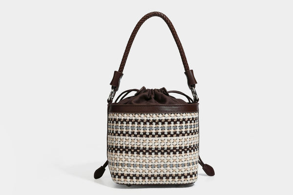 Small structured woven checker bucket bag with braided top handle, drawstring closure, and silver-tone hardware in black