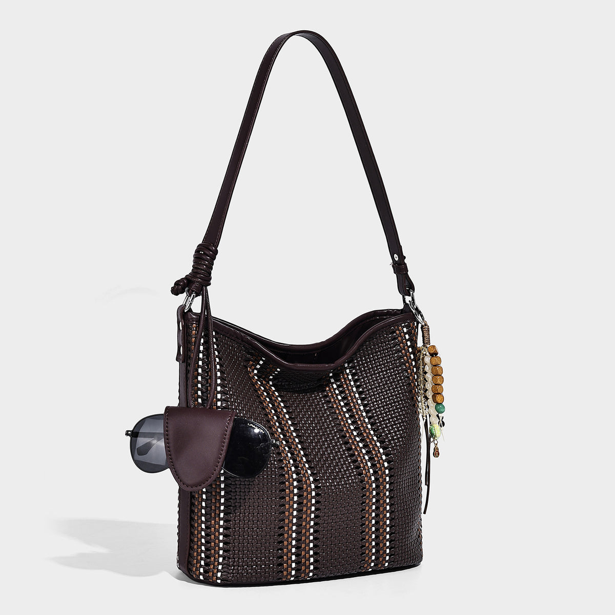 Woven bucket shoulder bag with leather-look trim, silver-tone hardware, and beaded tassel charm, detail view 16