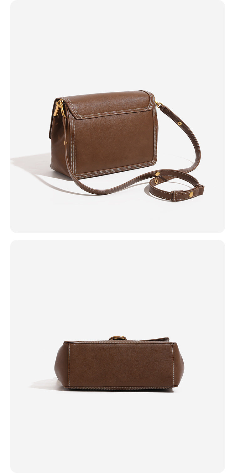 Structured flap shoulder bag with gold-tone circular turn-lock closure, white contrast stitching, and adjustable strap