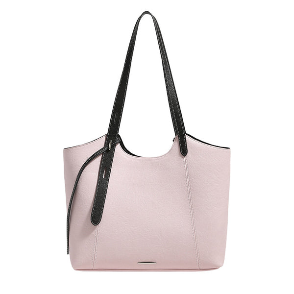 Structured trapezoidal tote bag with smooth leather-look finish, long black contrast shoulder straps, and dangling strap