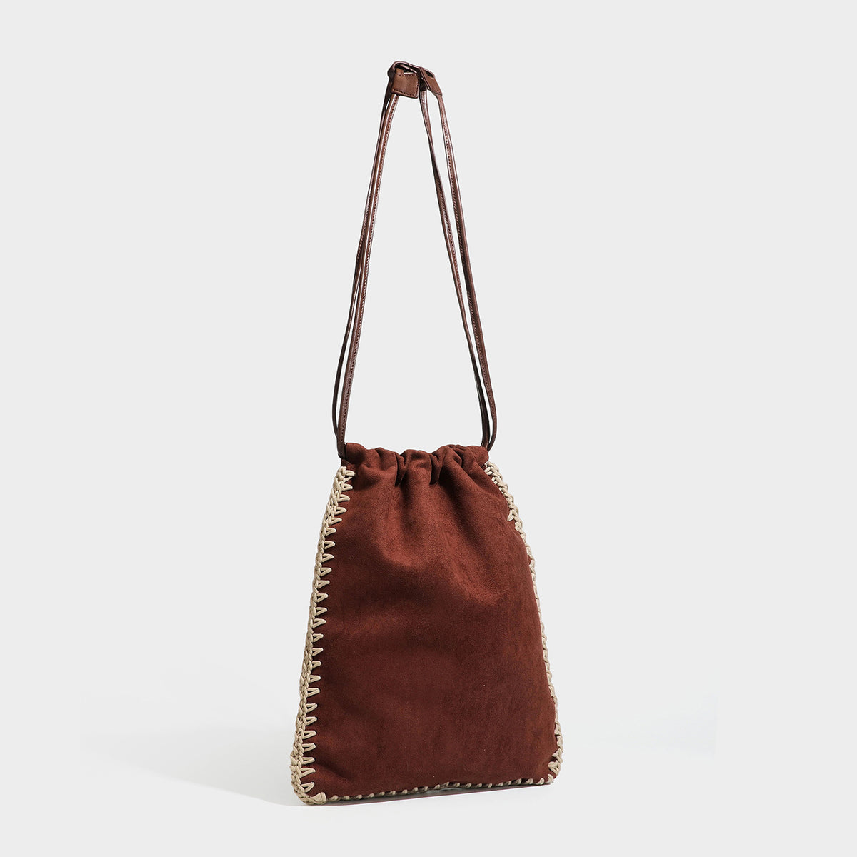 Matte suede-look drawstring bucket bag with cream braided woven edge trim and slim adjustable leather-look shoulder strap