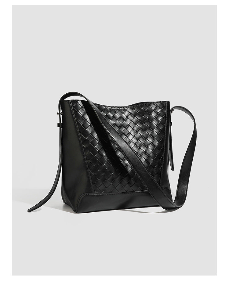 Large black bucket shoulder bag with diamond woven leather-look front panel, smooth side panels, magnetic snap closure, and