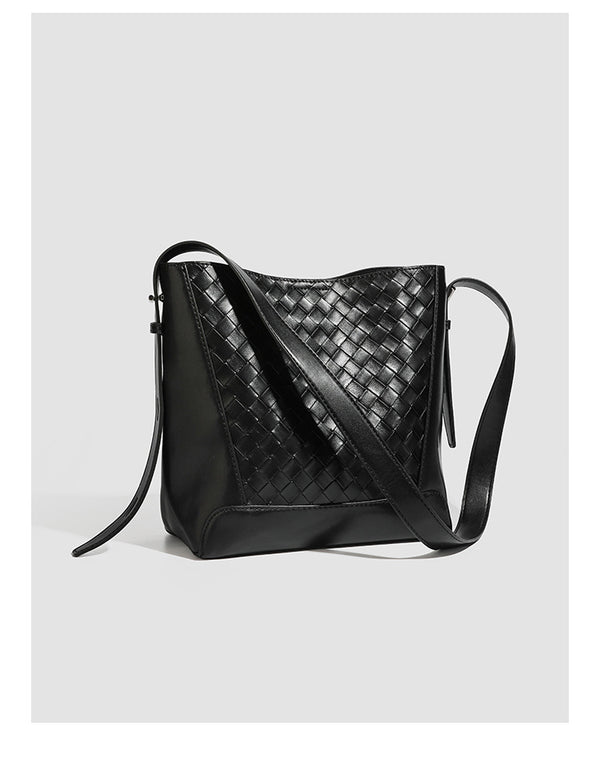 Large black bucket shoulder bag with diamond woven leather-look front panel, smooth side panels, magnetic snap closure, and