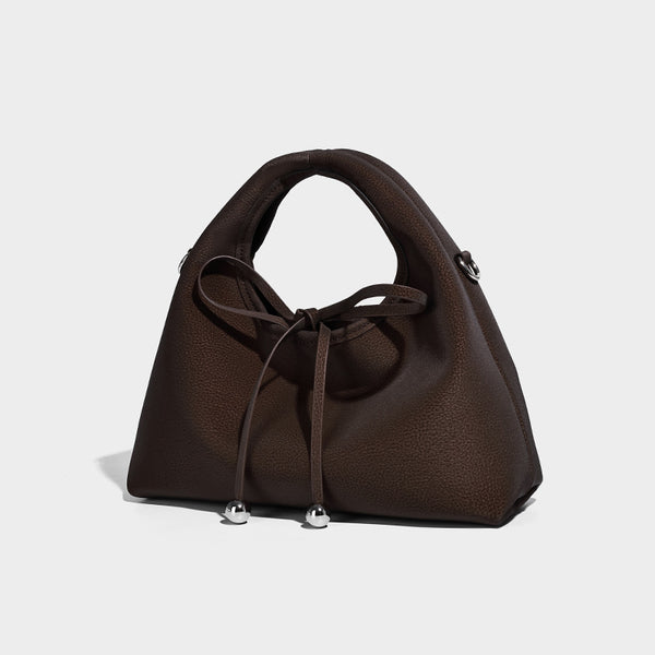 Pebbled matte trapezoid top-handle bag with drawstring bow closure, bead-tipped cords, silver-tone hardware, and detachable