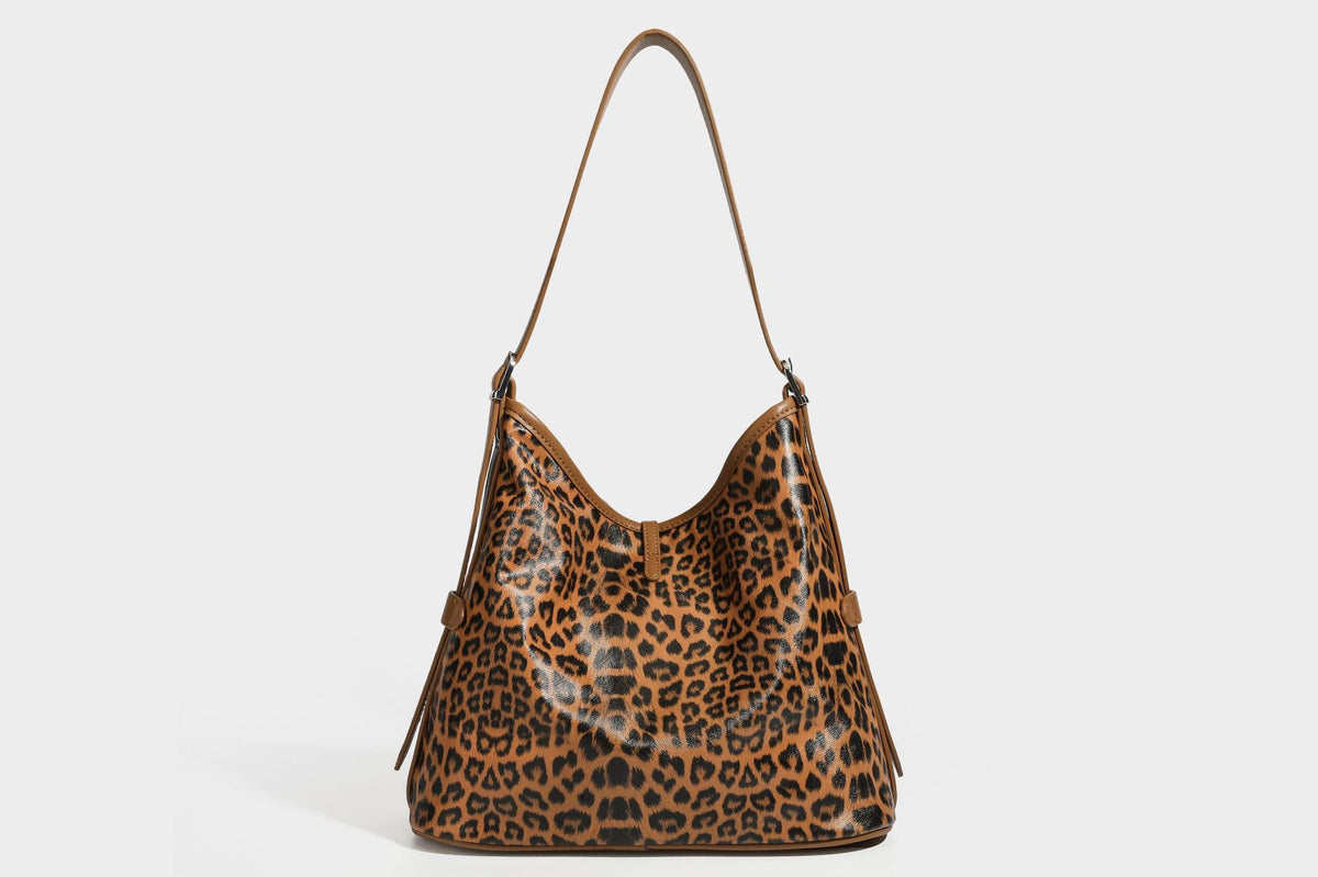 Slouchy leopard print shoulder hobo bag with black leather-look trim, tie-top closure, and single long strap, detail view 27
