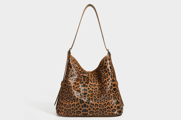 Slouchy leopard print shoulder hobo bag with black leather-look trim, tie-top closure, and single long strap, detail view 27