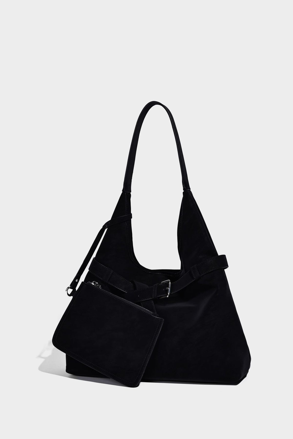 Slouchy oversized shoulder tote bag with matte textured finish, wrap-around buckle strap, and detachable front zip pouch