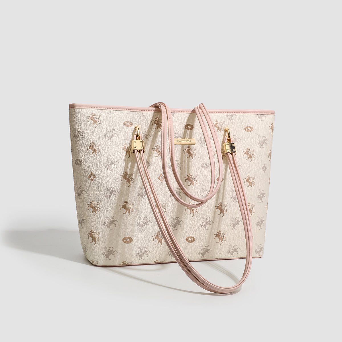 Cream structured tote bag with allover horse-and-crest print, blush-pink leather-look double shoulder straps, gold-tone
