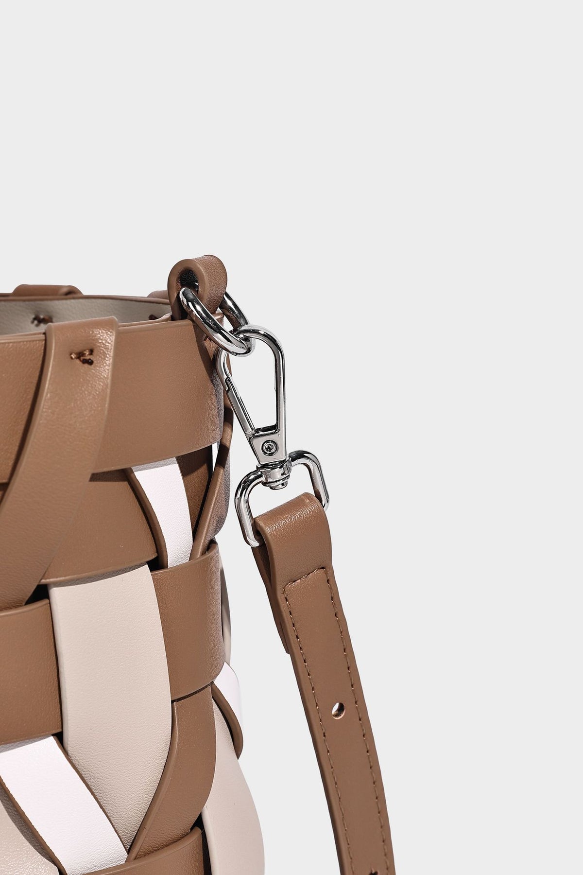 Small woven lattice bucket bag in tan and cream leather-look strips with drawstring top and detachable crossbody strap