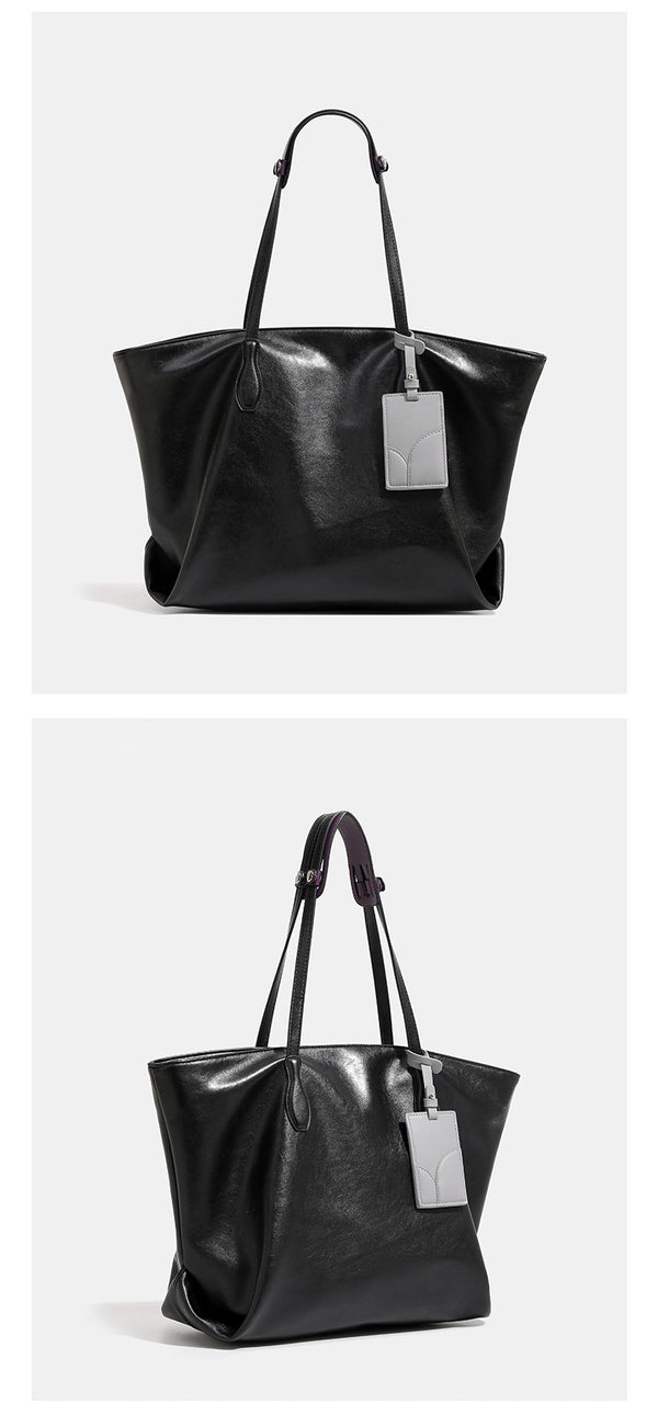 Large soft trapezoid tote bag with leather-look finish, dual shoulder straps, and gray hanging card tag, detail view 11