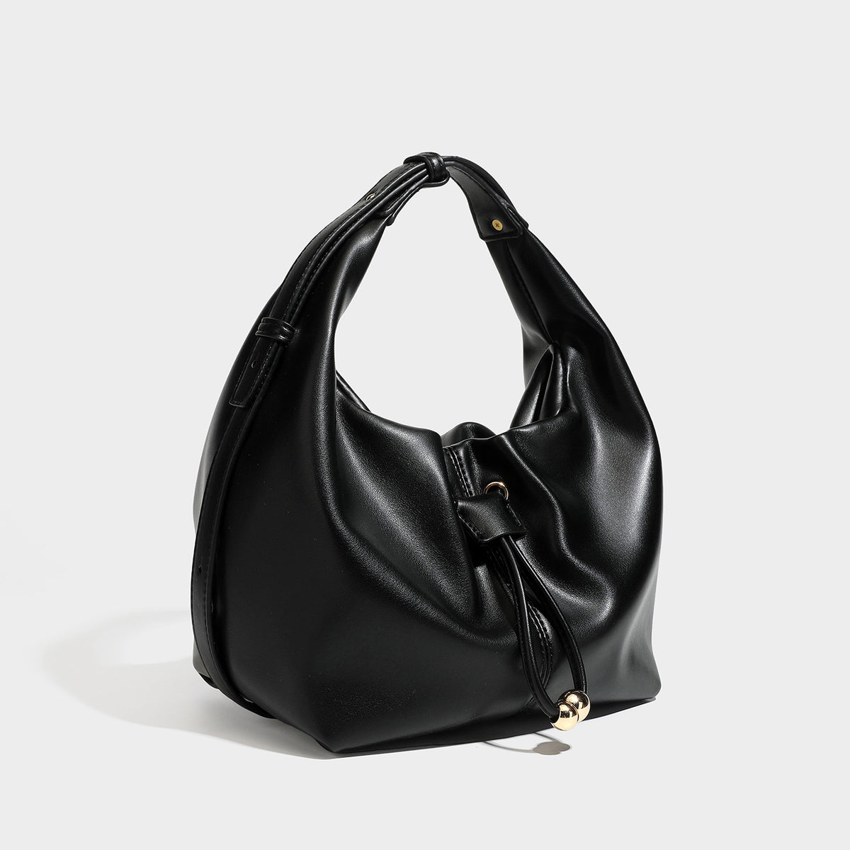 Slouchy hobo bag with smooth leather-look finish, drawstring cinch closure, and gold-tone bead hardware, detail view 6