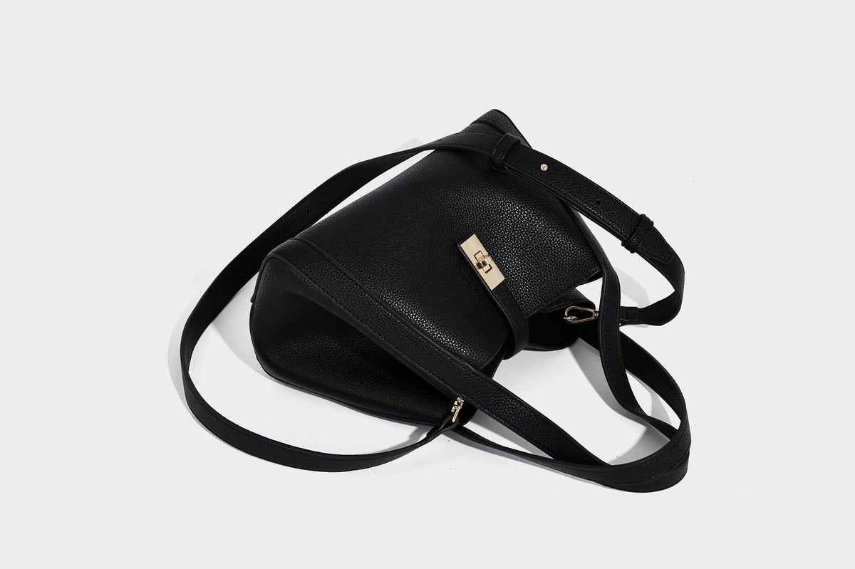 Structured trapezoid tote bag in taupe pebbled leather-look finish with gold-tone turn-lock hardware, dual top handles, and
