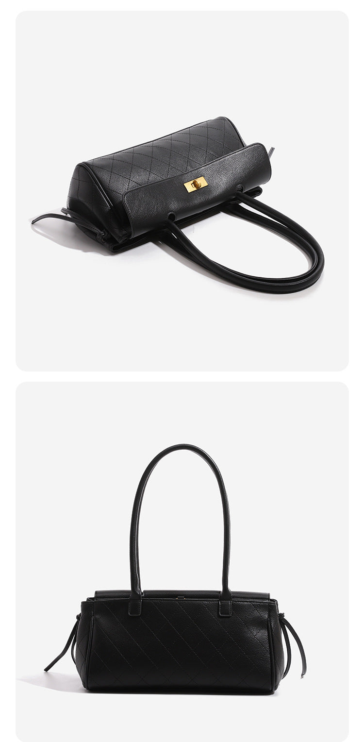 Structured quilted diamond top-handle underarm shoulder bag with gold-tone turn-lock flap closure and side tie straps, detail