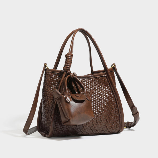 Strukturierte Tote Bag mit Webstruktur in Braun, glatten Besätzen in Lederoptik, geknoteten Tragegriffen und befestigtem Mini-Beutel mit Kordelzug