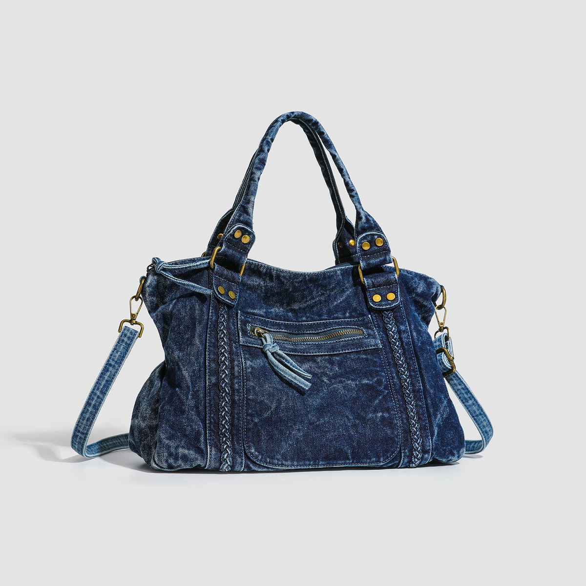Large washed blue denim-look shoulder bag with gold-tone rings and rivets, top zip closure, front zip pocket, and adjustable