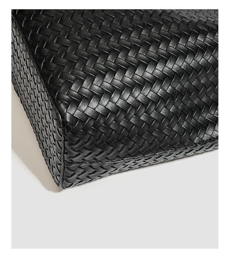 Large black basket-weave leather-look tote bag with long braided shoulder straps and matching woven zip pouch, detail view 23