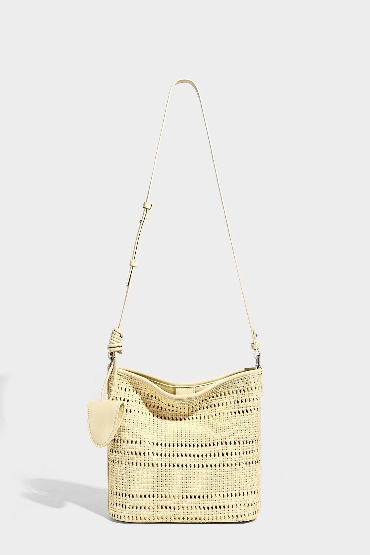 Handwoven open-weave shoulder bag with leather-look trim, knotted adjustable strap, and clip-on sunglasses sleeve pouch