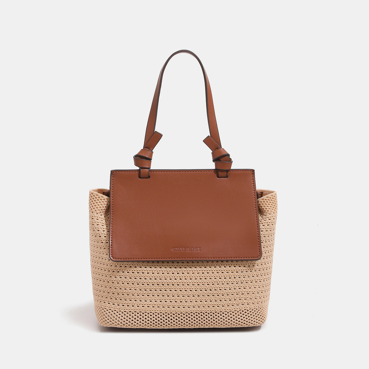 Structured woven tote bag with smooth leather-look front flap panel, knotted top handles, and detachable crossbody strap