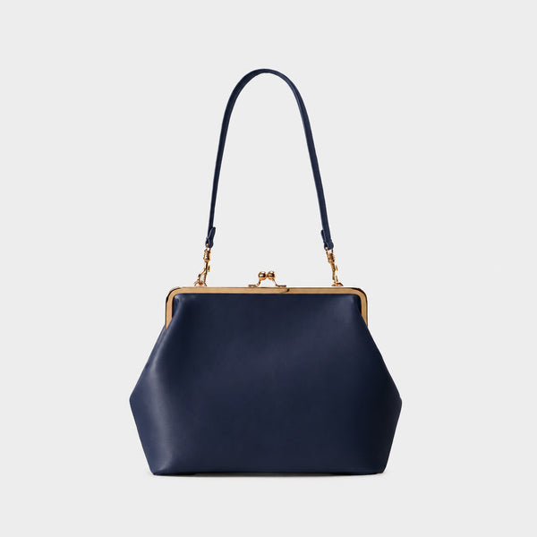 Oversized kiss-lock frame handbag with gold-tone metal clasp and smooth leather-look finish, detail view 9